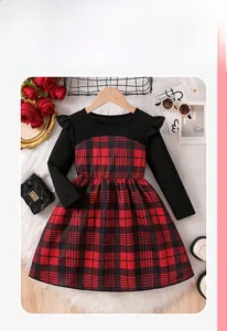 Detail of red and black plaid girl's dress with black knit top and ruffled shoulders