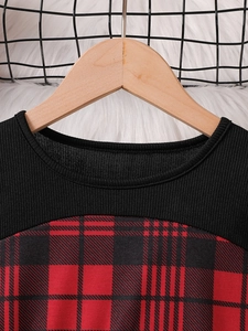 Girls' red plaid New Year dress featuring black ribbed knit top and round neckline