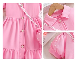 Detail of pink girls dress showing collar lace, pearl buttons and puffed sleeve texture