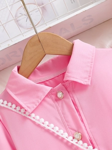 Pink preppy girl dress with puff sleeves and lace trim on a wooden hanger