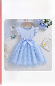 Detail of blue tulle princess dress with 3D butterfly accents and a silk waist bow