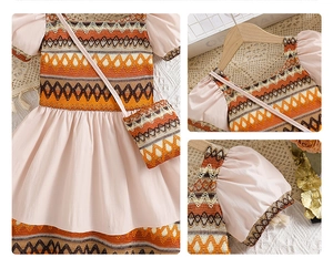 Detail of pink bohemian girl dress with geometric jacquard neckline and mini crossbody bag