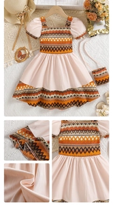 Detail of bohemian girls' dress showing puff sleeves, mixed patterns, and textured fabric
