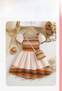 Detail of girl's bohemian dress with patchwork geometric prints and puff sleeves