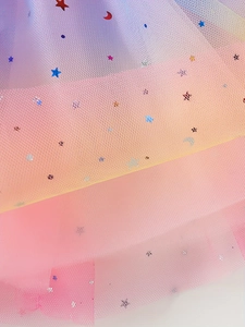 Close-up of girls' layered tulle skirt with gradient colors and star moon sequins