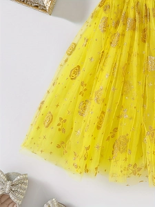 Detail of yellow tulle skirt featuring sparkling gold rose and star glitter prints