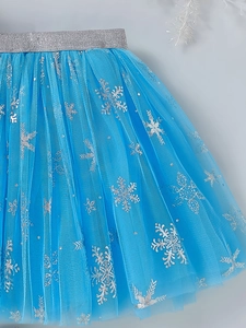 Close-up of girls ice blue tutu skirt featuring silver glitter snowflake patterns
