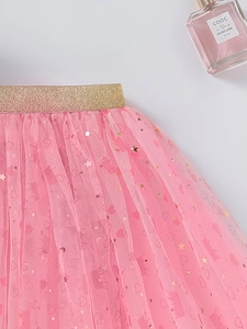 Detail of pink tutu skirt with golden star sequins and glitter elastic waistband