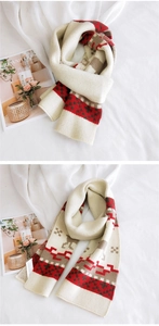 Detail of soft knit Christmas deer scarf with red and brown pixel geometric patterns