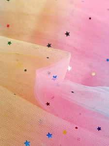 Macro detail of gradient tulle fabric with colorful star sequins for princess skirts