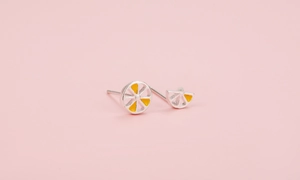 Macro detail of asymmetric S925 silver lemon earrings with yellow enamel fruit slices