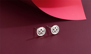 Macro detail of S925 sterling silver button earrings with hallmark and refined texture