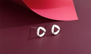 Detail of s925 silver irregular geometric earrings with smooth mirror finish