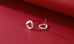 Detail of s925 silver triangle studs showing hollow design and honeycomb texture back