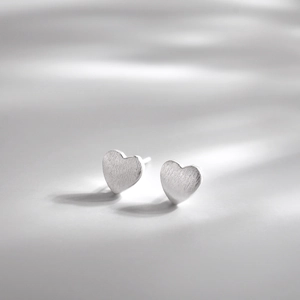 Minimalist S925 sterling silver heart stud earrings with a brushed metal texture
