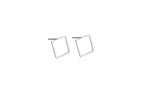 Macro view of geometric square stud earrings in silver finish with hollow design