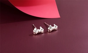 Macro detail of S925 sterling silver butterfly stud earrings with polished finish