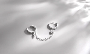 Macro view of S925 silver chain earring featuring letter H charm and shiny zircon stone