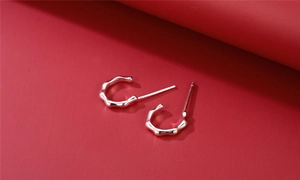 Macro detail of S925 sterling silver bamboo hoop earrings with polished finish