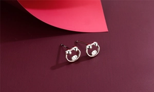 Macro view of S925 sterling silver cartoon stud earrings with polished finish