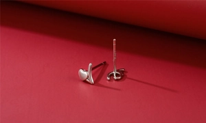 Macro view of S925 sterling silver heart-shaped stud earrings showing metal stamp