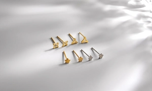 Macro shot of minimalist silver and gold geometric stud earrings set in various shapes