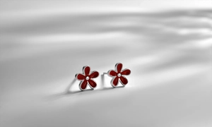Macro view of S925 silver red floral stud earrings with enamel petals and central silver bead