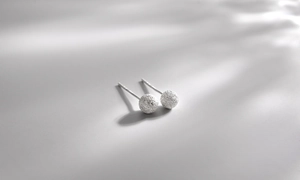 Detailed view of 925 sterling silver ball earrings with a textured matte finish