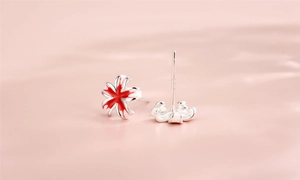 Macro shot of S925 sterling silver peach blossom earrings with red enamel detail