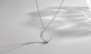 Close-up of S925 sterling silver crescent moon pendant with sparkling zircon inlay