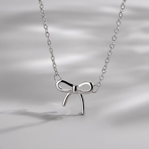 Elegant S925 sterling silver bow pendant necklace with a minimalist fine chain design