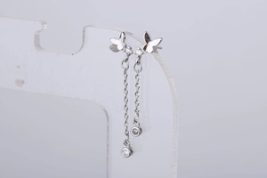 Detail of silver butterfly tassel earrings with micro-set zircons and long chain drops