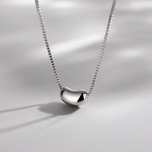 Polished silver bean pendant necklace with box chain for women in a minimalist style