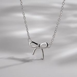 Elegant S925 sterling silver bow pendant necklace with delicate link chain for women