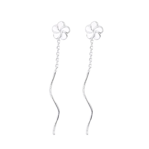 Detail of elegant silver long chain earrings with small flower studs and wavy metal wire