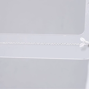 Minimalist S925 sterling silver drop earrings with leaf sprout tassel on acrylic stand