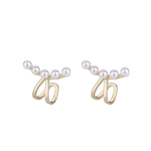 Minimalist gold ear cuffs with a curved row of five white pearls for non-pierced ears