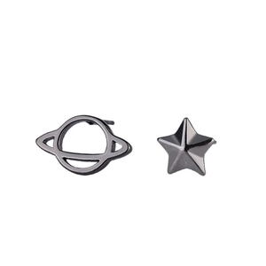 Asymmetric black celestial earrings featuring star and planet motifs on white background