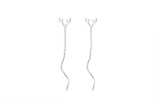 Detailed close-up of silver antler drop earrings with long chain and wave needle design