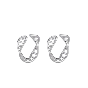 Detail of silver double helix ear cuffs showing polished finish and sleek spiral design