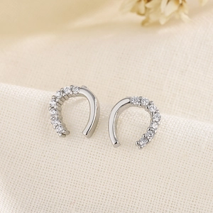 Elegant silver U-shaped horseshoe stud earrings featuring micro-pave cubic zirconia stones