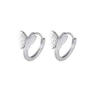 Detail of silver butterfly hoop earrings with matte and polished wing textures