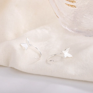 Elegant S925 silver butterfly drop earrings on white fabric background