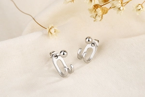 Detail shot of minimalist S925 silver double-line bead earrings on natural linen background