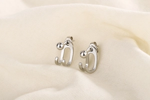 Detailed close-up of S925 silver double-line hook earrings with polished bead studs