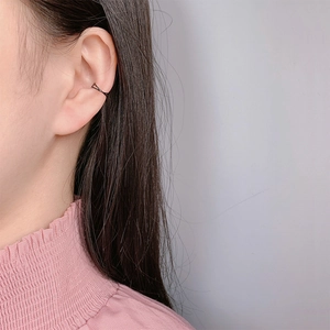 Minimalist black U-shaped crisscross ear cuff for non-pierced ears worn on the cartilage