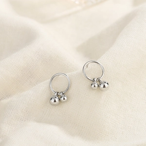 Minimalist S925 sterling silver hoop earrings with dangling beads on soft linen fabric