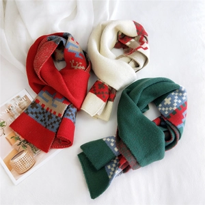 Christmas knit scarf with reindeer patterns in red, white and green, soft winter warmth