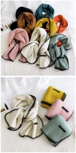 Detail of multi-color knitted scarves showing handmade edges and brand woven labels