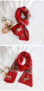 Detailed view of red Christmas knit scarf featuring festive reindeer and snowflake patterns